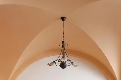 a chandelier hanging from a ceiling in a room at Elizabeth Hotel in Athens