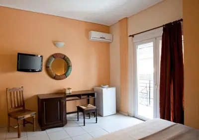 a bedroom with a refrigerator and a tv on the wall at Elizabeth Hotel in Athens