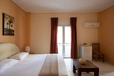 a bedroom with a large bed and a window at Elizabeth Hotel in Athens
