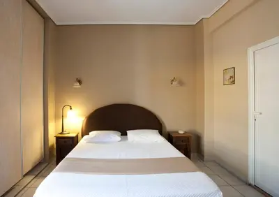 a bedroom with a large bed with white sheets at Elizabeth Hotel in Athens
