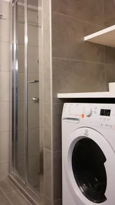 a washing machine in a bathroom with a shower at Modern Downtown Flat near the Acropolis by UPSTREET in Athens