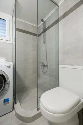 a bathroom with a toilet and a glass shower at Modern Flat next to the USA Embassy by UPSTREET in Athens