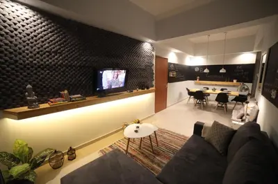 a living room with a couch and a tv on a wall at Ports Crossroad B in Piraeus
