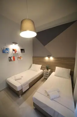 a bedroom with two beds and a light fixture at Ports Crossroad B in Piraeus