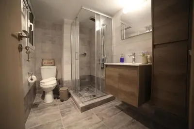 a bathroom with a toilet and a glass shower at Ports Crossroad B in Piraeus