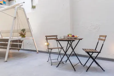 a table and chairs in a room with a ladder at Ports Crossroad B in Piraeus