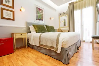 a bedroom with a bed and a red dresser at Acropolis Ami Boutique Hotel in Athens