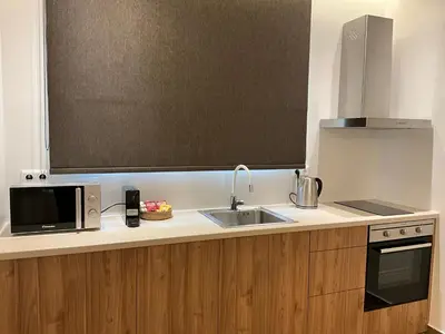 a kitchen with a sink and a microwave at Elegant Plaka Retreat by Liberty's Canvas in Athens