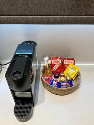 a cell phone sitting next to a basket of snacks at Elegant Plaka Retreat by Liberty's Canvas in Athens