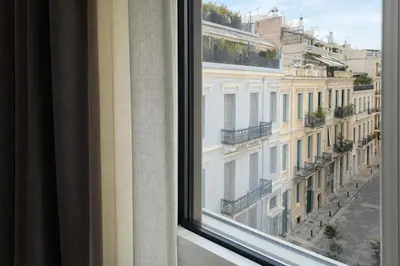 a window with a view of a building at Elegant Plaka Retreat by Liberty's Canvas in Athens