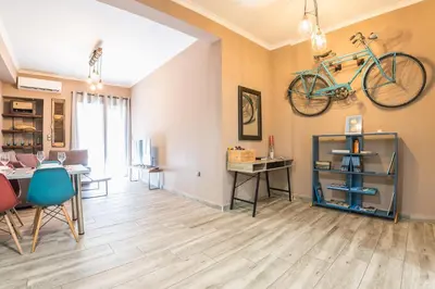 a living room with a bike hanging on the wall at Stylish Luxury Apartment near Acropolis at Neos Kosmos metro station in Athens