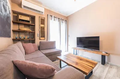 a living room with a couch and a table at Stylish Luxury Apartment near Acropolis at Neos Kosmos metro station in Athens