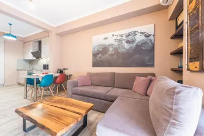 a living room with a couch and a table at Stylish Luxury Apartment near Acropolis at Neos Kosmos metro station in Athens