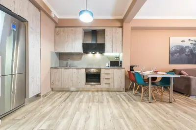 a kitchen and dining room with a table and chairs at Stylish Luxury Apartment near Acropolis at Neos Kosmos metro station in Athens