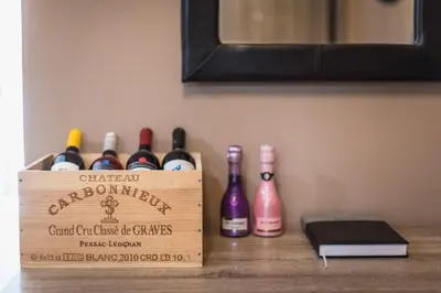 a wooden box of wine bottles on a table at Stylish Luxury Apartment near Acropolis at Neos Kosmos metro station in Athens