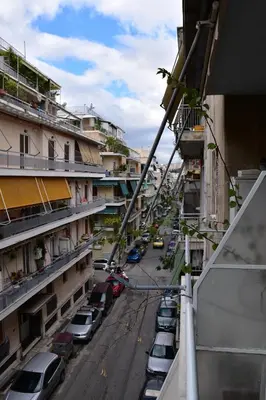 a view of a street with parked cars and buildings at Stylish Luxury Apartment near Acropolis at Neos Kosmos metro station in Athens