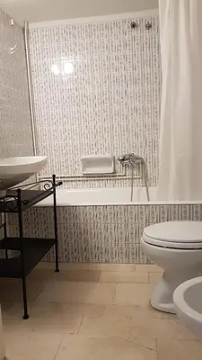 a bathroom with a tub and a toilet and a sink at Menta errathens Apartment - Athens Center, 5 BD, 2 BATH in Athens