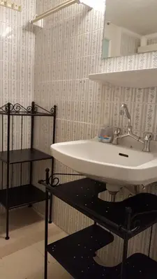 a white sink in a bathroom with a shelf at Menta errathens Apartment - Athens Center, 5 BD, 2 BATH in Athens