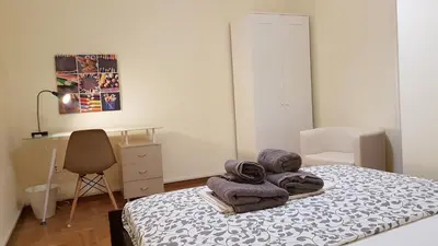 a bedroom with a bed with towels on it at Menta errathens Apartment - Athens Center, 5 BD, 2 BATH in Athens