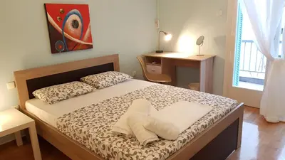 a bedroom with a bed and a desk and a window at Menta errathens Apartment - Athens Center, 5 BD, 2 BATH in Athens
