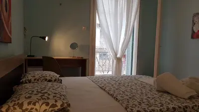 a bedroom with a bed with a window and a desk at Menta errathens Apartment - Athens Center, 5 BD, 2 BATH in Athens