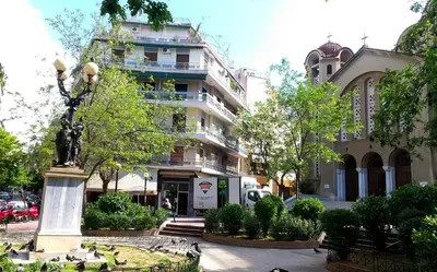 a statue in a park in front of a building at Menta errathens Apartment - Athens Center, 5 BD, 2 BATH in Athens