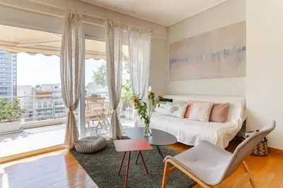 a living room with a couch and a table at Skyview Penthouse / Central Athens in Athens