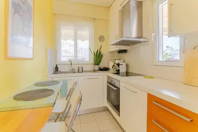 a kitchen with a counter and a table and chairs at Skyview Penthouse / Central Athens in Athens