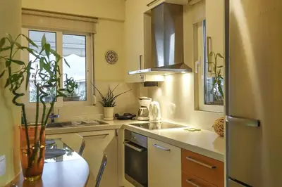 a kitchen with a vase on a table at Skyview Penthouse / Central Athens in Athens