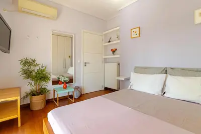 a bedroom with a large bed and a tv at Skyview Penthouse / Central Athens in Athens