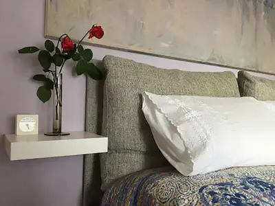 a vase with a flower on a table next to a bed at Skyview Penthouse / Central Athens in Athens