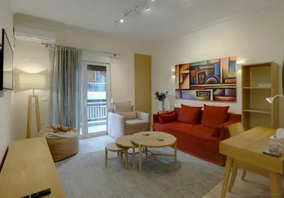 a living room with a red couch and a table at Charming City Centre Flat Kolonaki in Athens