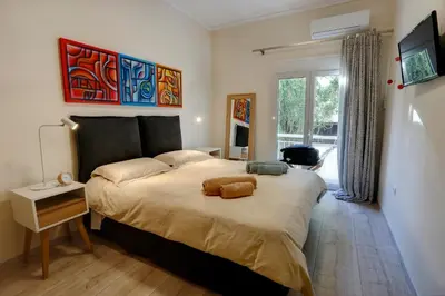 a bedroom with a large bed and a window at Charming City Centre Flat Kolonaki in Athens