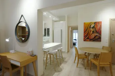 a dining room and kitchen with a table and chairs at Charming City Centre Flat Kolonaki in Athens
