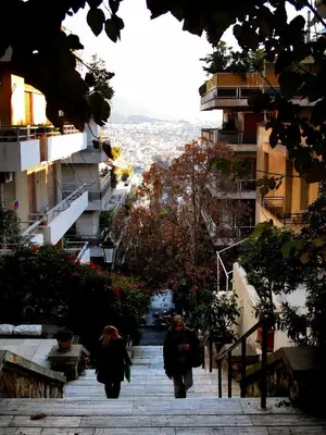 a person walking down a stairs in a city at Charming City Centre Flat Kolonaki in Athens