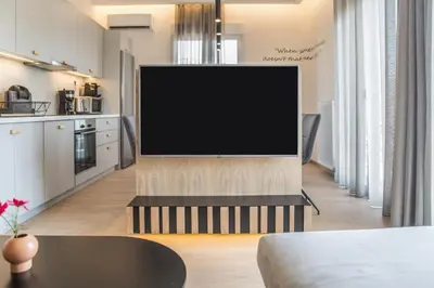 a flat screen tv on a stand in a living room at Athens Life in Athens