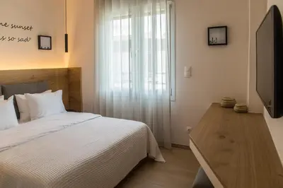a bedroom with a bed and a tv and a window at Athens Life in Athens