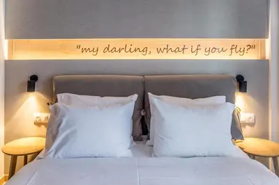 a bedroom with a bed with a sign on the headboard at Athens Life in Athens