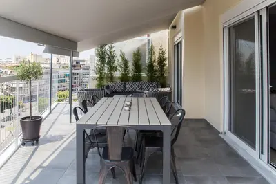 a table and chairs on the balcony of a building at Athens Luxury in Athens