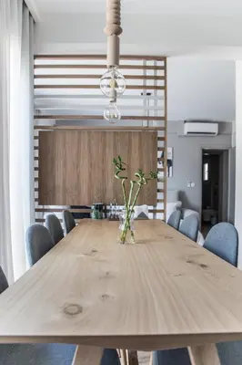 a wooden table in a dining room with blue chairs at Athens Luxury in Athens