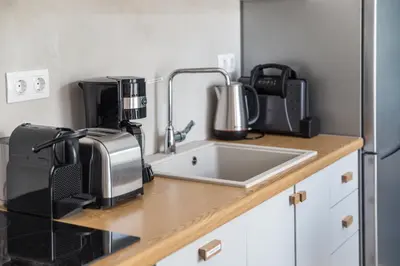 a kitchen counter with a sink and a microwave at Athens Luxury in Athens