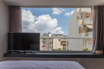 a bedroom with a large window with a flat screen tv at Athens Luxury in Athens