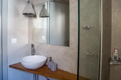 a bathroom with a bowl sink and a shower at Athens Luxury in Athens
