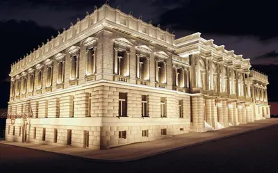 a white building with lights on it at night at Athens beautiful SUITE by Gela in Athens