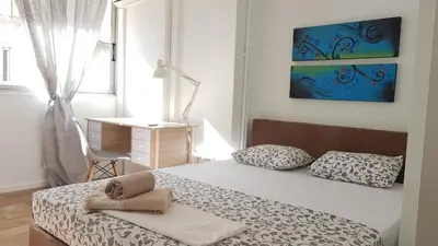 a bedroom with a bed and a desk and a window at Errathens Cherry and Berry Apartments - Athens Center in Athens