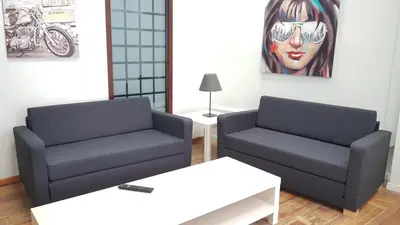 a living room with two chairs and a painting at Errathens Cherry and Berry Apartments - Athens Center in Athens