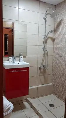 a bathroom with a shower and a sink and a toilet at Errathens Cherry and Berry Apartments - Athens Center in Athens