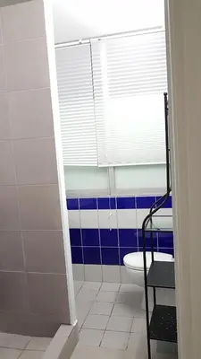 a bathroom with a toilet and a window at Errathens Cherry and Berry Apartments - Athens Center in Athens