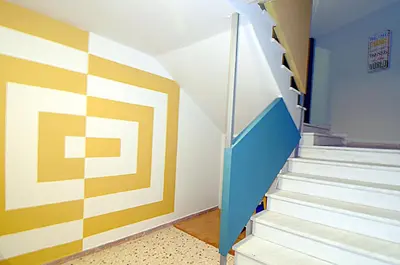 a hallway with stairs and a colorful wall at Urban Art Experience with Acropolis View in Athens