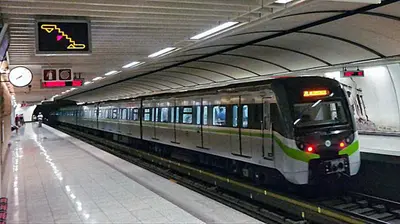 a subway train pulling into a subway station at Urban Art Experience with Acropolis View in Athens
